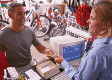 A businesswoman serving a cusotmer in a bicycle shop