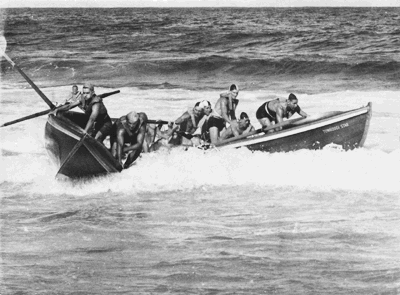 Port Kembla and Corrimal teams fighting out the boat race finish at Wollongong Beach, c1940.