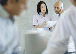 Image: Lady with papers, man on phone