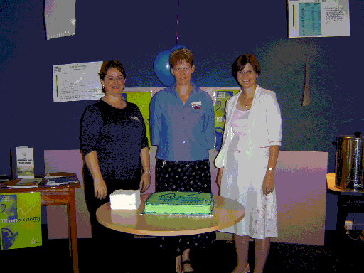 Selena Seng, Stephanie McDonald and Tanya Lucas with the celebratory '100 years of Statistics' cake