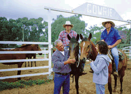 People and horses on a property