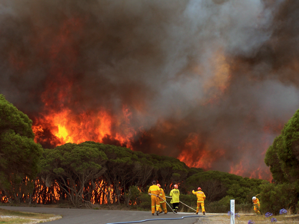 Photograph: A bushfire rages near Merimbula, New South Wales, New Years Day, 2006 – courtesy Stephen Kemp, Bureau of Mereorology.