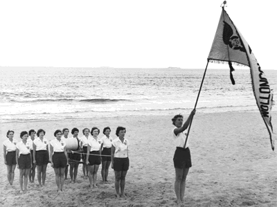 Wollongong Ladies Surf Club march past team, summer of 1952--53 -- Jean Duff (far left) team captain, called directions such as 'reel down'.
