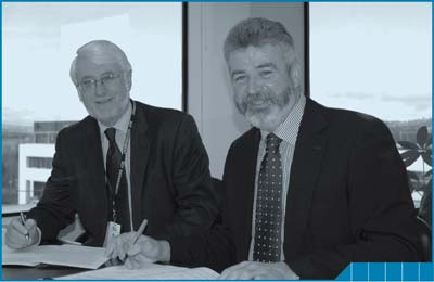 Brian Pink and Andrew Cappie-Wood sign the ACT IDP in June, 2008