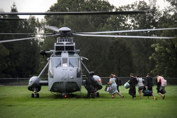 January 2011 – Local residents board a Sea King helicopter at the Laidley sports ground for transfer to Laidley hospital to escape rising flood waters. Operation QUEENSLAND FLOOD ASSIST.