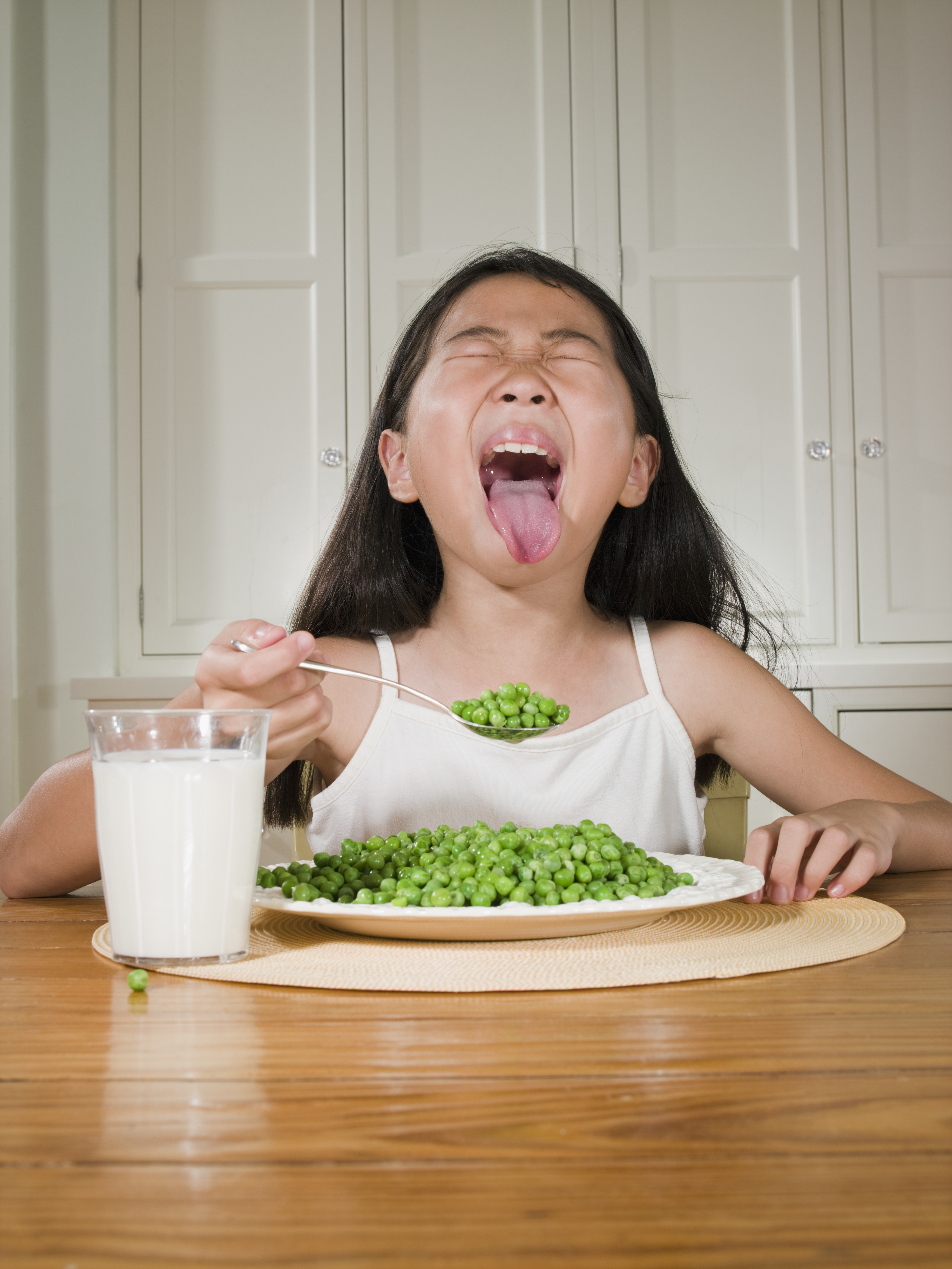 Image: Girl eating peas
