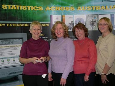 Photo: Library staff of the State Library of Tasmania pictured infront of the Statistics Across Australia display.