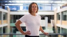 national census spokesperson emily walter leans on a glass balustrade at abs house and looks directly at the camera