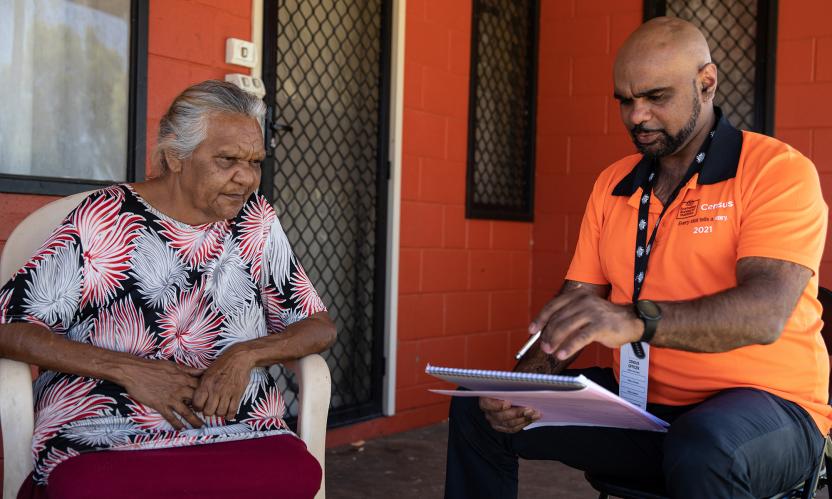 Census field staff going through Census form with a member of the community