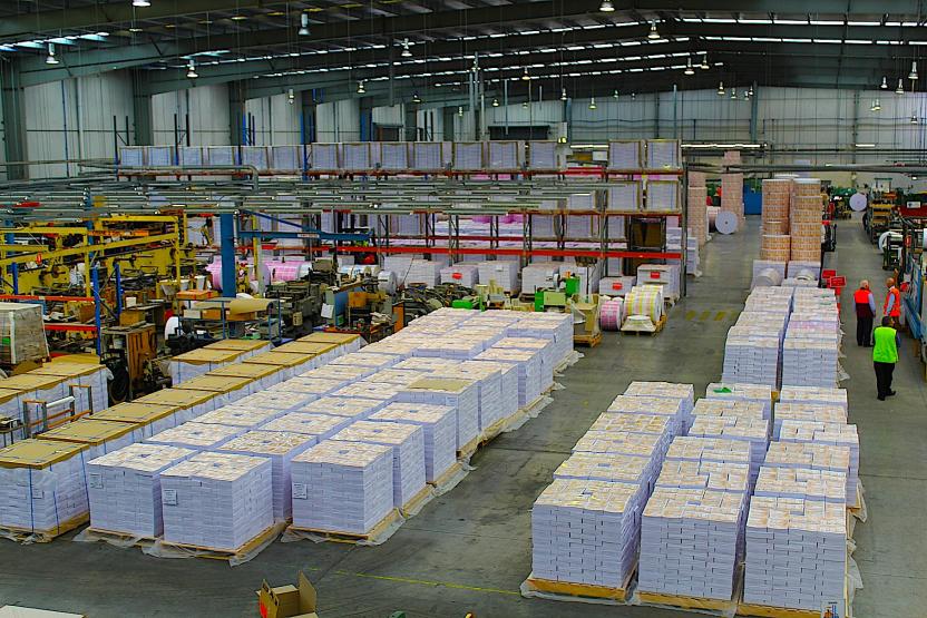 Photo of warehouse with bulk pallets of printed Census forms