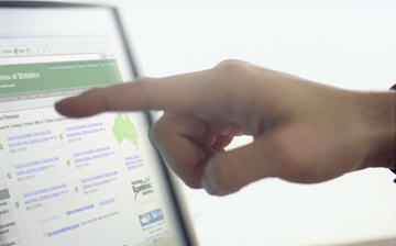 A hand points at a computer screen showing the Census Home Page, 2006 Census